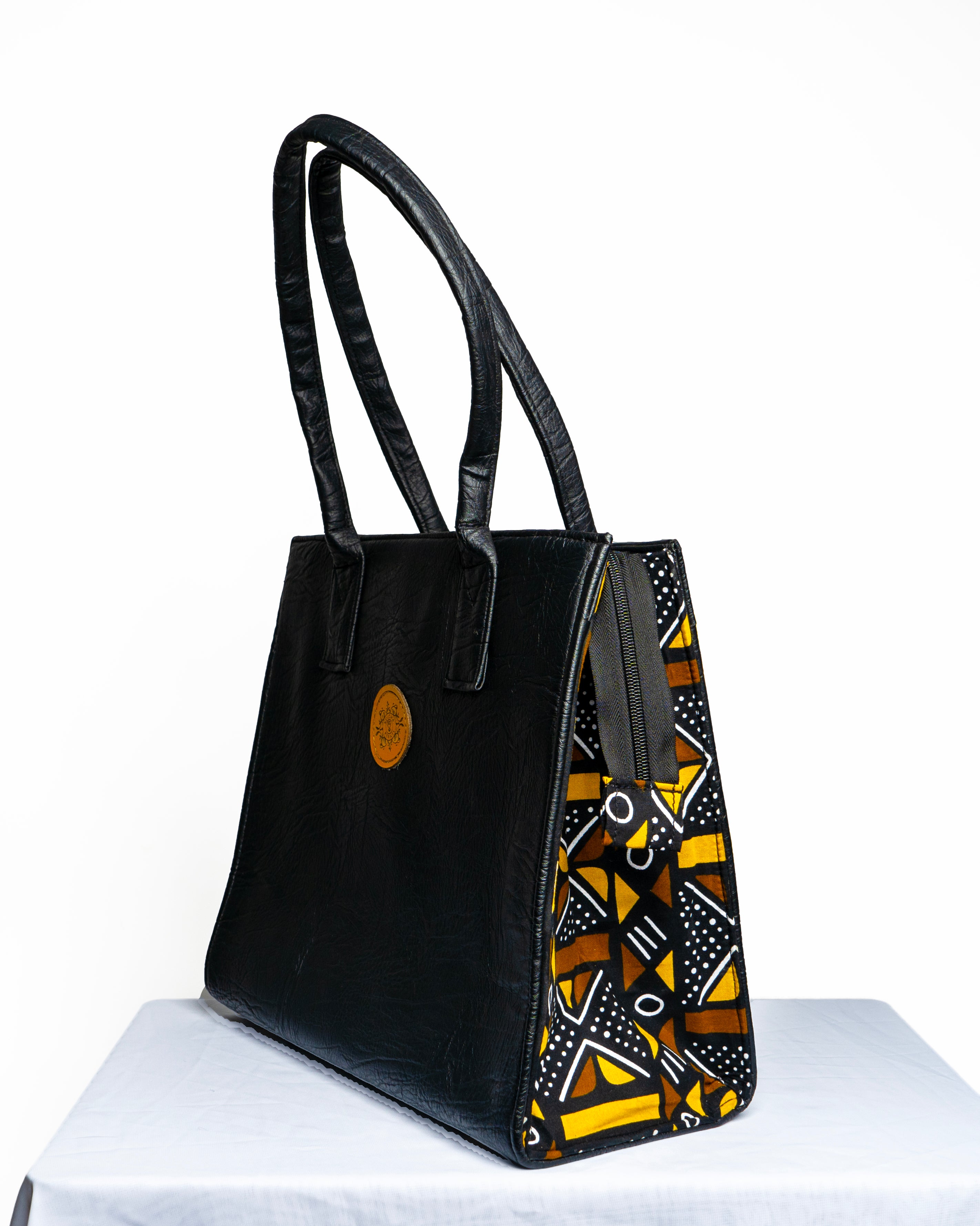 Handmade Black Soft Leather and Ankara/ African print mid sized handbag.